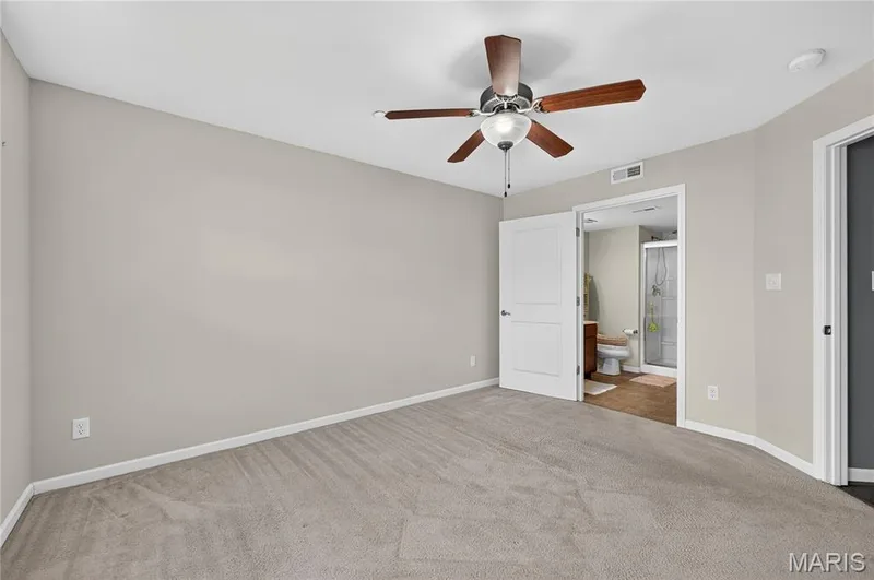 Carpeted flooring, neutral wall tones, ceiling fan with integrated lighting, and white interior doors — 313 Bramblett Hills, O'Fallon, MO 63366