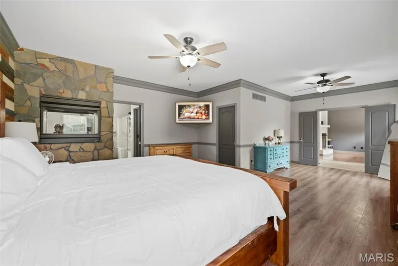 Double sided fireplace leading to bathroom — 1 Priority Drive N, Wentzville, MO 63385