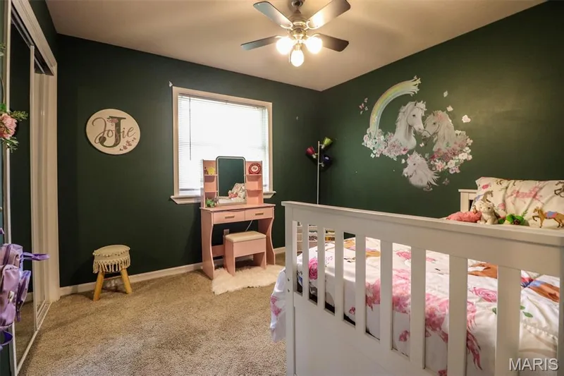 Carpeted bedroom with a ceiling fan and window with blinds — 12 Pyrenees Drive, Lake St. Louis, MO 63367