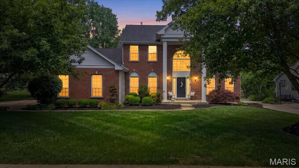 Traditional brick facade with white siding accents and a dark shingle roof — 17821 Wilderness Cliff Court, Wildwood, MO 63005