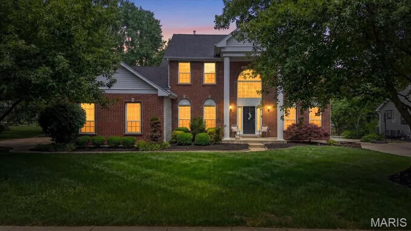 Traditional brick facade with white siding accents and a dark shingle roof — 17821 Wilderness Cliff Court, Wildwood, MO 63005