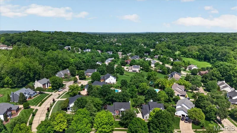 Residential neighborhood featuring mature trees and established homes with varied architectural styles — 17821 Wilderness Cliff Court, Wildwood, MO 63005