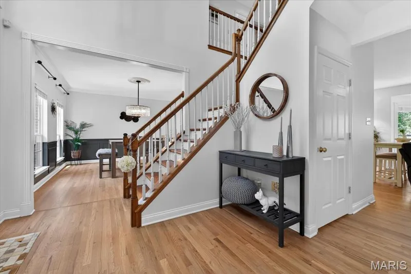 Hardwood flooring extending throughout the entryway and adjacent room — 17821 Wilderness Cliff Court, Wildwood, MO 63005