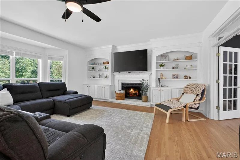 Spacious living area featuring light wood-finish flooring and a bay window — 17821 Wilderness Cliff Court, Wildwood, MO 63005