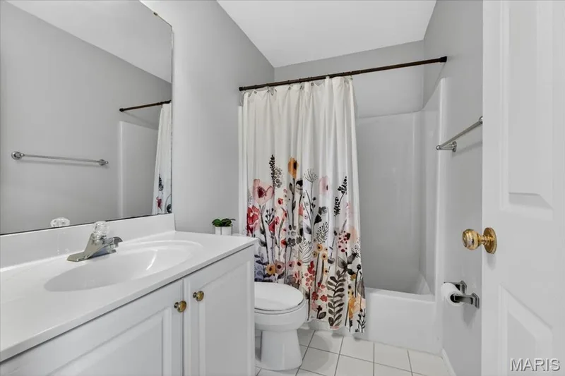 Bathroom featuring a white vanity with integrated sink, chrome faucet, and gold-toned hardware — 17821 Wilderness Cliff Court, Wildwood, MO 63005