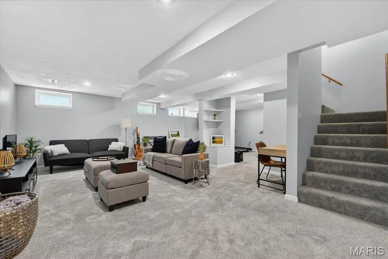 Expansive lower level living space featuring light gray carpeting, recessed lighting, and multiple egress windows — 17821 Wilderness Cliff Court, Wildwood, MO 63005