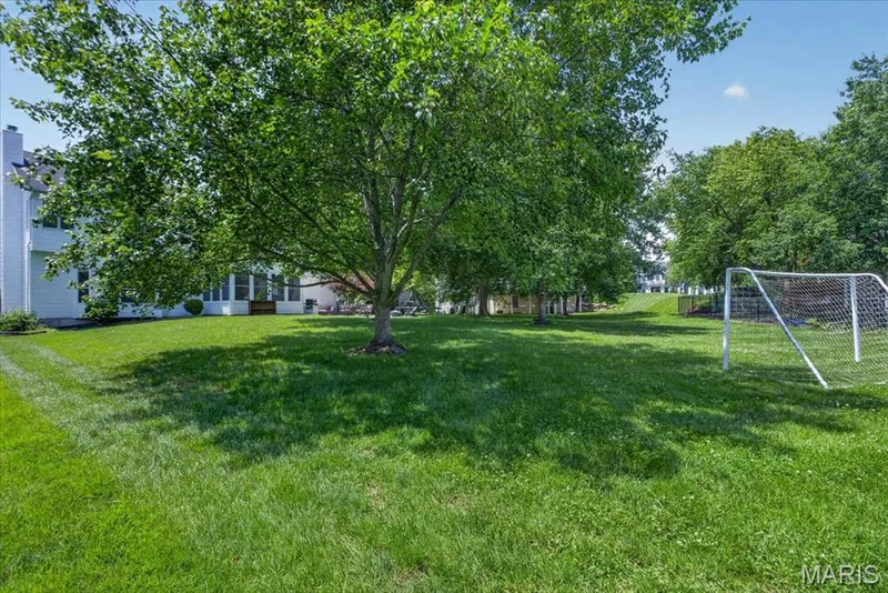 Expansive green lawn with mature trees providing natural shading — 17821 Wilderness Cliff Court, Wildwood, MO 63005