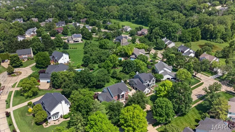 Residential neighborhood featuring mature trees and manicured lawns — 17821 Wilderness Cliff Court, Wildwood, MO 63005