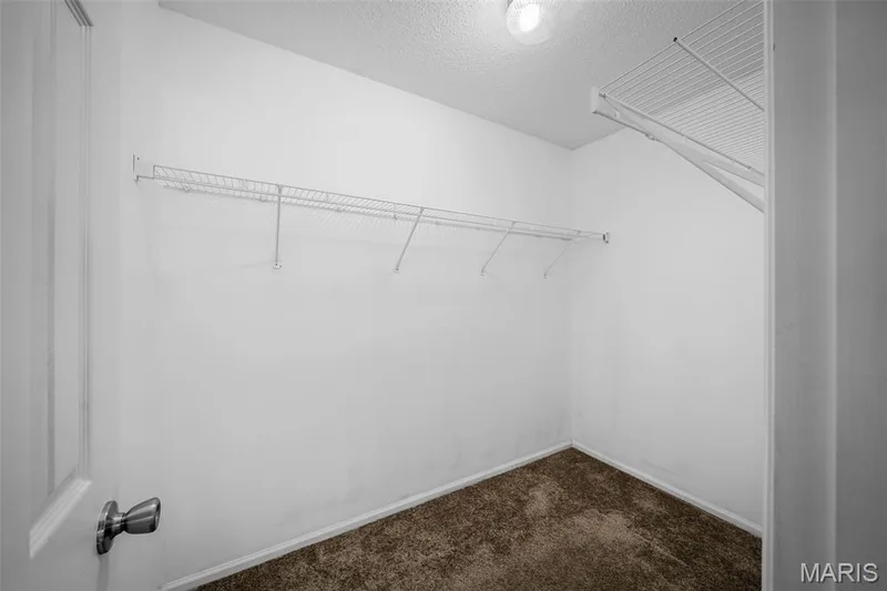 Recessed storage shelves, overhead wire shelving, and a textured ceiling — 120 Bromley Court, O'Fallon, MO 63368