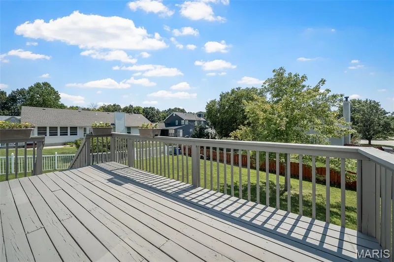 Spacious wooden deck with railing, offering a broad outdoor area — 120 Bromley Court, O'Fallon, MO 63368