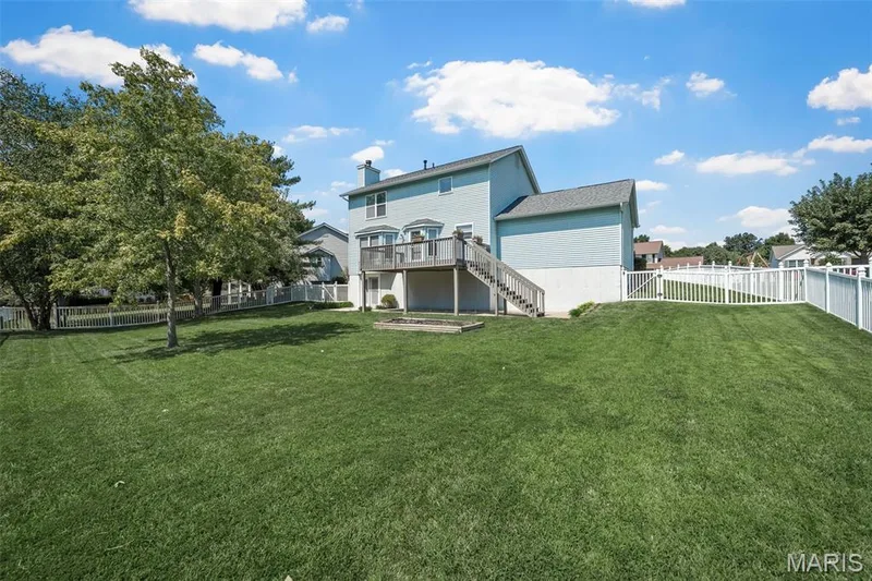 Expansive green lawn with mature trees and white picket fencing — 120 Bromley Court, O'Fallon, MO 63368