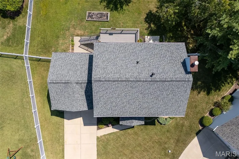 Asphalt shingle roofing, composite decking, and manicured green lawn — 120 Bromley Court, O'Fallon, MO 63368