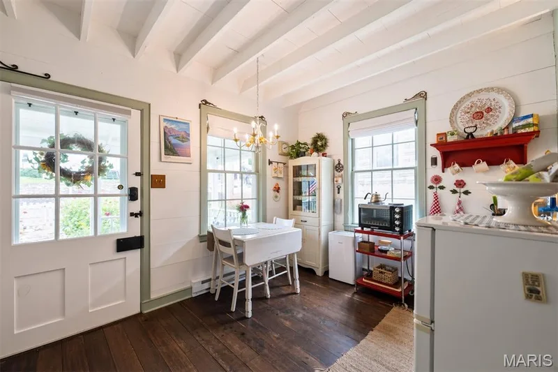 Exposed ceiling beams, white shiplap walls, dark wood-finish flooring, and a multi-pane glass door — 215 Jackson Street, Augusta, MO 63332