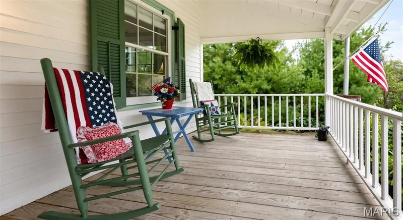 Covered front porch with a peaceful setting — 215 Jackson Street, Augusta, MO 63332