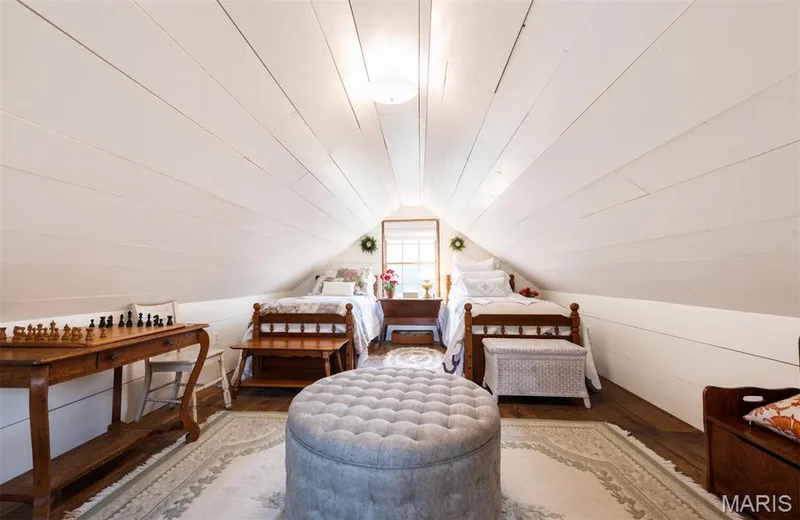 Sloped white shiplap walls and ceiling, recessed window, dark wood-finish flooring — 215 Jackson Street, Augusta, MO 63332