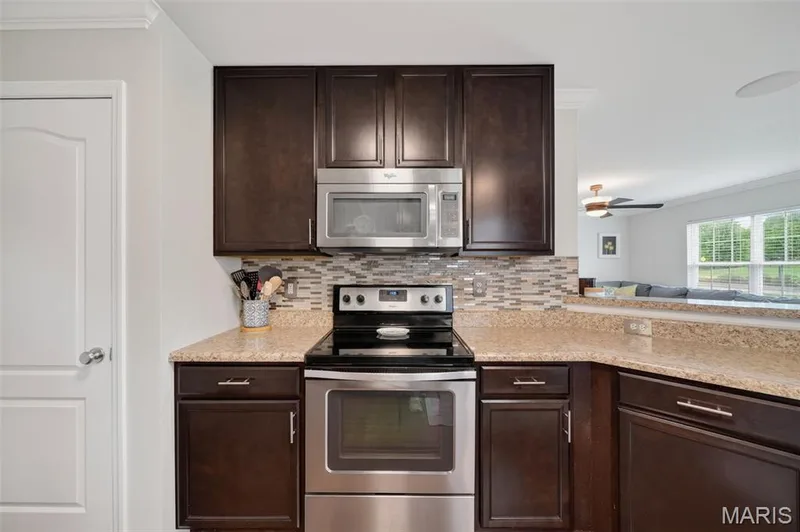 Gorgeous backsplash & custom cabinets with matching finishes! — 3120 Bentwater Place, St Charles, MO 63301