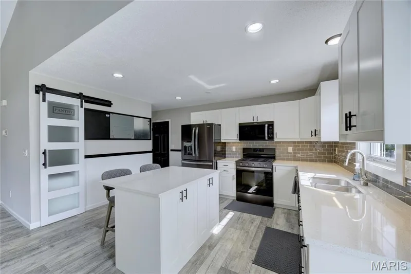 Beautiful updated kitchen with quartz countertops. — 9 Carriage Way E, St Peters, MO 63376