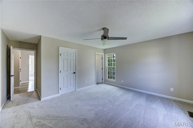 Primary bedroom with walk-in closet. — 9 Carriage Way E, St Peters, MO 63376
