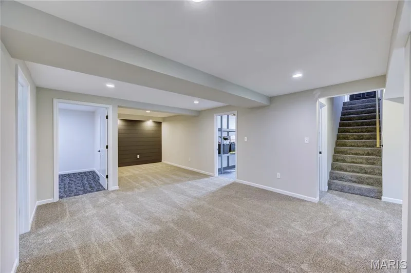 View of rec room looking towards flex room, storage area and media nook. — 9 Carriage Way E, St Peters, MO 63376