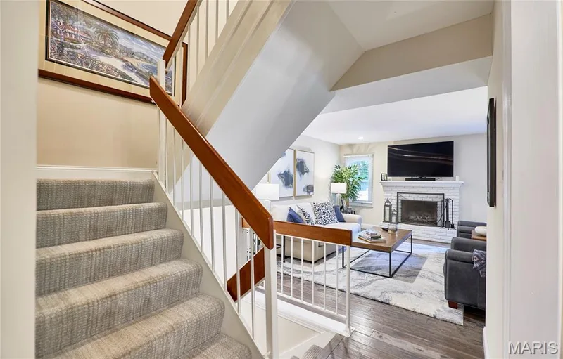 New carpeting on stairway. Upstairs is the primary bedroom with ensuite and two other bedrooms and full hall bath — 16463 Cobbleskille Drive, Chesterfield, MO 63017