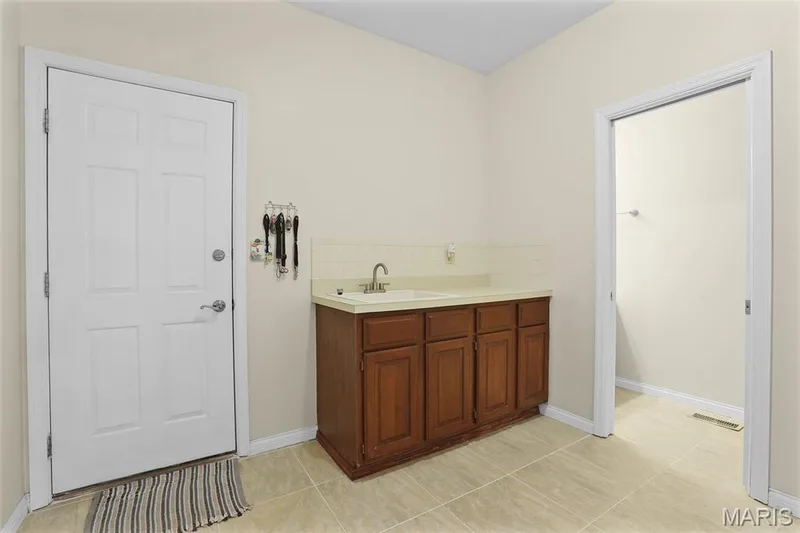 MAIN LEVEL MUD ROOM/LAUNDRY ROOM WITH ADJOINING HALF BATH — 1154 S Charlemagne Drive, Lake St. Louis, MO 63367