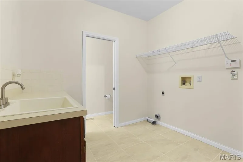 MAIN LEVEL MUD ROOM/LAUNDRY ROOM WITH ADJOINING HALF BATH — 1154 S Charlemagne Drive, Lake St. Louis, MO 63367