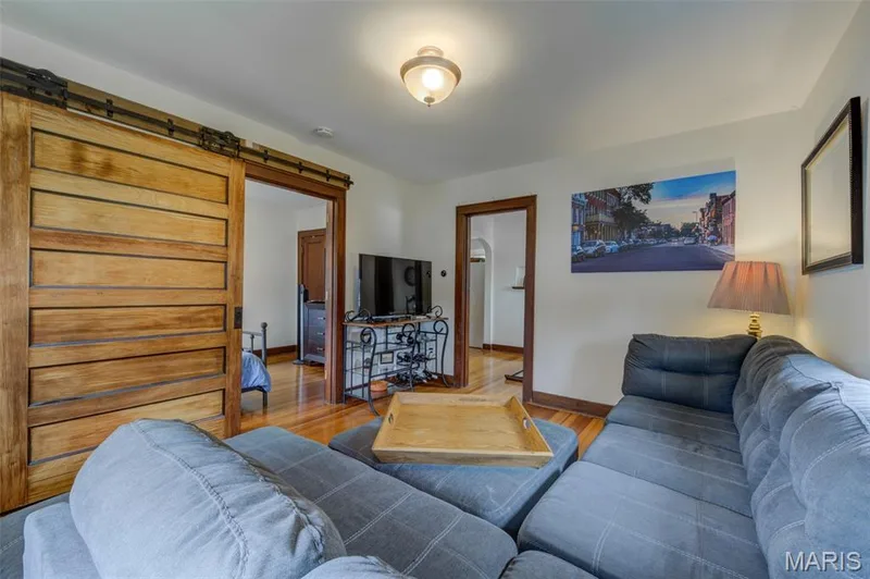 The main floor bedroom has a barn door entry off the living room. — 2009 N 3rd Street, St Charles, MO 63301