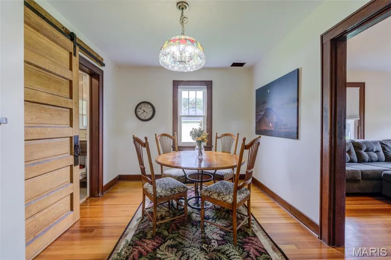 The dining room has a barn door entry into the updated bathroom. — 2009 N 3rd Street, St Charles, MO 63301