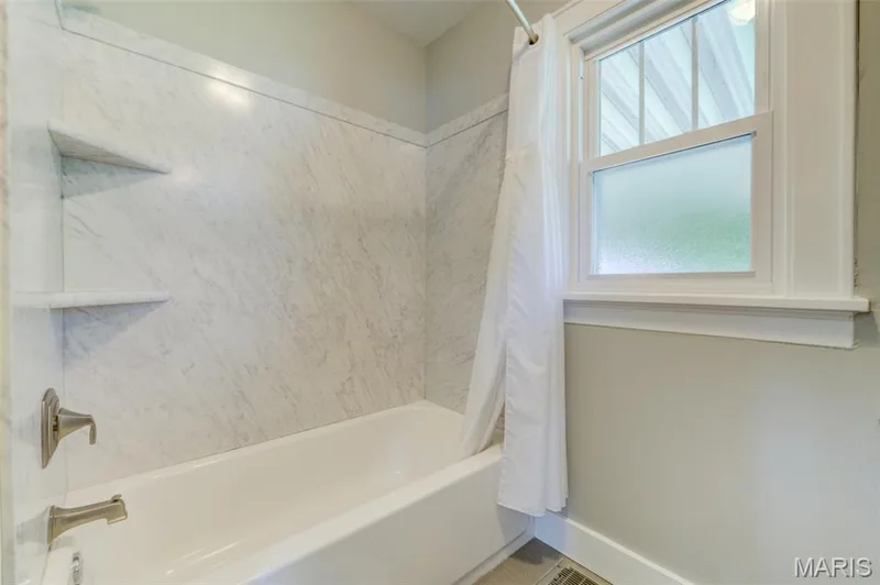The bathroom has a shower/tub enclosure - easy to clean (no tile). — 2009 N 3rd Street, St Charles, MO 63301