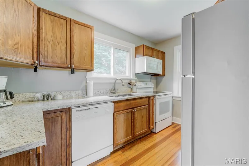 The kitchen boasts granite counter-tops and modern appliances. — 2009 N 3rd Street, St Charles, MO 63301