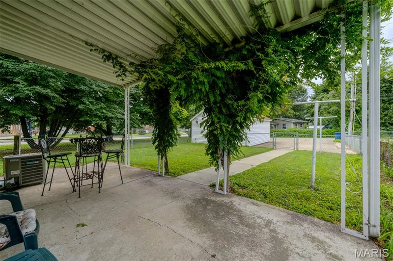 Rear patio overlooking the fenced rear yard and storage garage. — 2009 N 3rd Street, St Charles, MO 63301