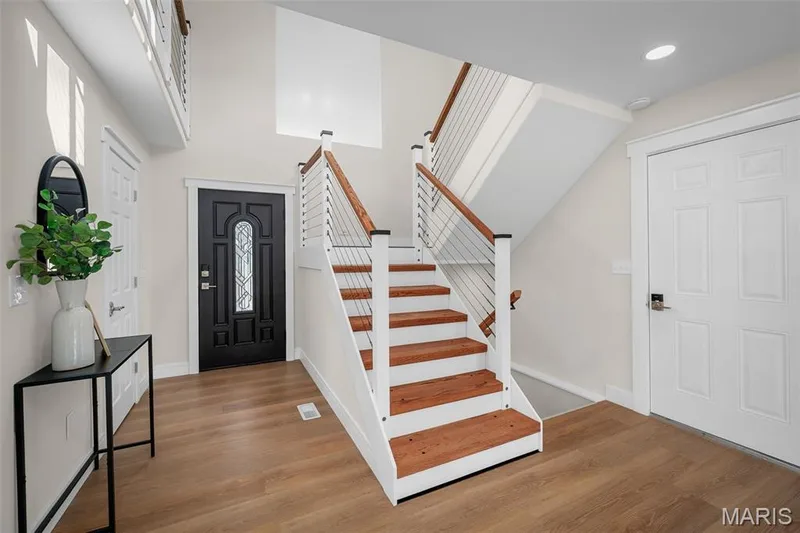 The LVP is throughout most of the home. The modern stairs with wire cables and chunky steps! — 14 Bayside Court, Lake St. Louis, MO 63367