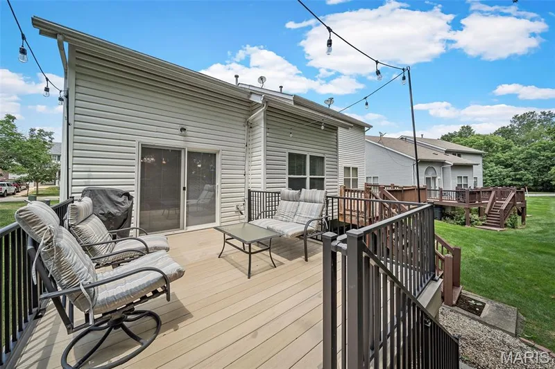 Newer composite decking with stairs to the ground level — 605 Timber Creek Trail, O'Fallon, MO 63368