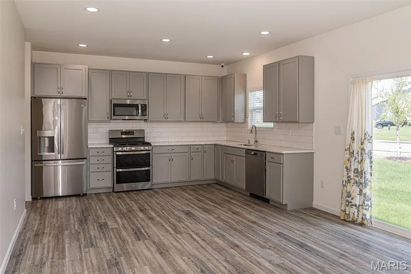 Kitchen features stainless steel appliances with gas range. — 812 Colony Ridge Court, Foristell, MO 63348