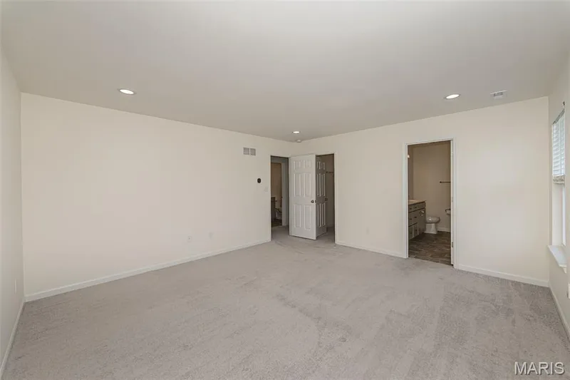 Primary Bedroom looking into the walk-in closet and ensuite bathroom. — 812 Colony Ridge Court, Foristell, MO 63348