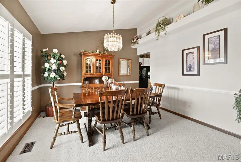Window with plantation shutters, tray ceiling, crown molding, chair rail, and an architectural display ledge — 38 Fawn Valley Circle, St Peters, MO 63376