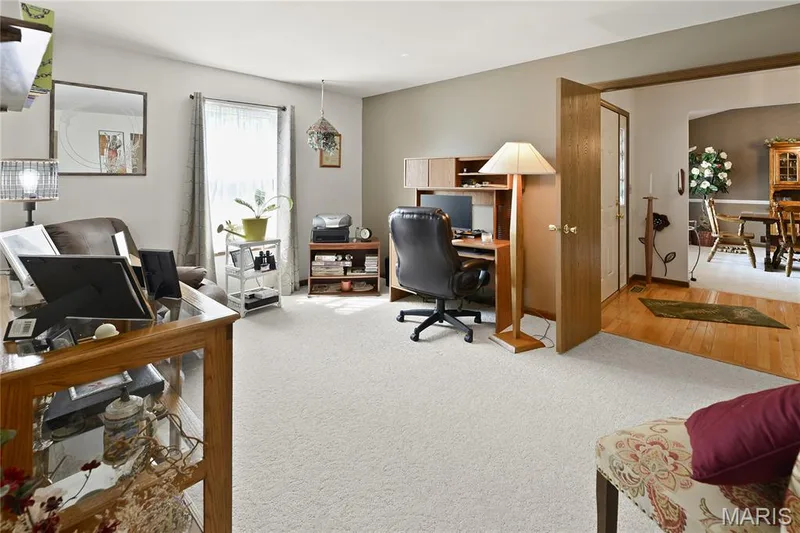 Plush carpeting and a built-in wood-finish desk with shelving define this versatile room — 38 Fawn Valley Circle, St Peters, MO 63376