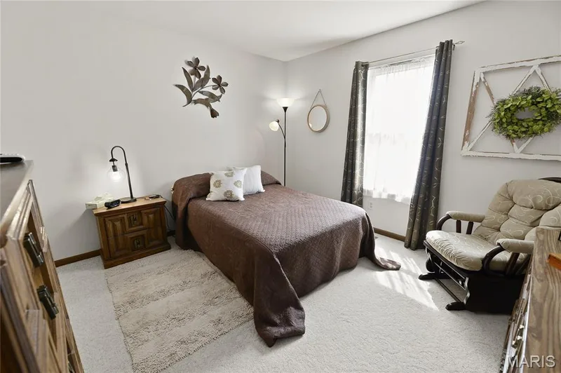 Soft carpeting, white walls, and a window with sheer and blackout curtains — 38 Fawn Valley Circle, St Peters, MO 63376