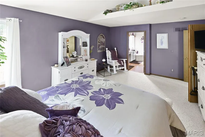 Tray ceiling, carpet flooring, and a doorway leading to an additional space — 38 Fawn Valley Circle, St Peters, MO 63376