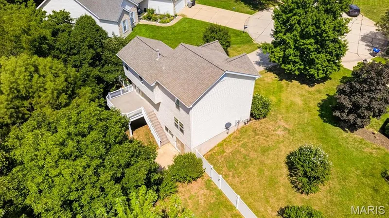 Two-story residence with a multi-level deck and surrounding mature trees — 53 Lions Head Court, O'Fallon, MO 63368