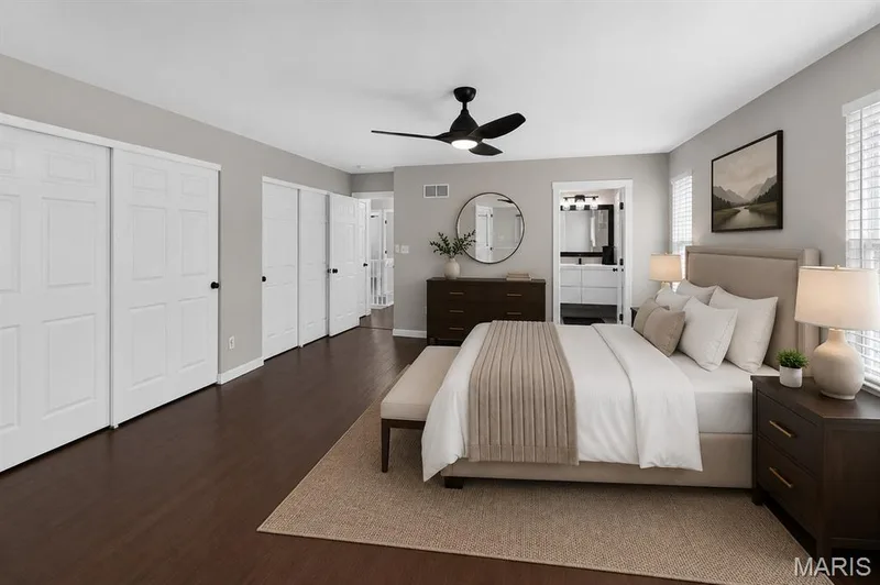 Wood-finish flooring, white paneled doors, ceiling fan with integrated lighting, and multiple windows with blinds — 53 Lions Head Court, O'Fallon, MO 63368