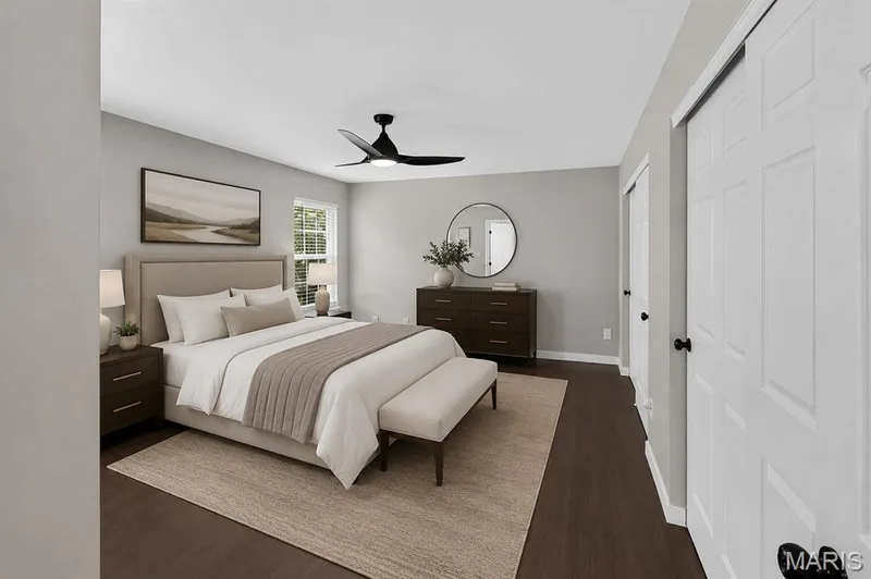 Wood-finish flooring throughout, modern ceiling fan, single window with blinds, and recessed closet with sliding doors — 53 Lions Head Court, O'Fallon, MO 63368