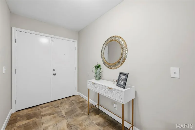 Entry foyer opens to an inviting living room featuring a vaulted ceiling and cozy wood burning fireplace. — 3034 Willow Wood Drive, St Charles, MO 63303