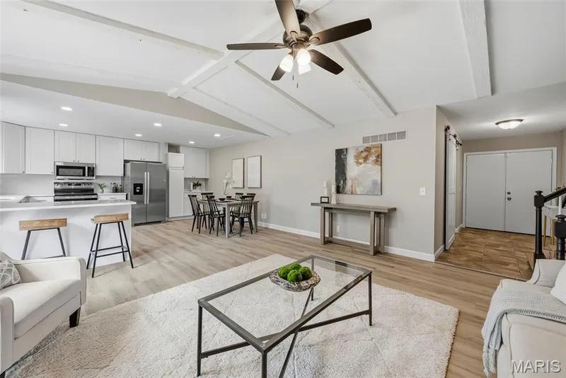The living room, breakfast room, and kitchen feature professionally painted interiors and new LVP flooring. — 3034 Willow Wood Drive, St Charles, MO 63303