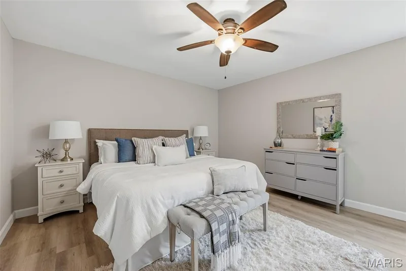 Upper level primary suite features a professionally painted interior, LVP flooring, ceiling fan with light, and en suite bath. — 3034 Willow Wood Drive, St Charles, MO 63303