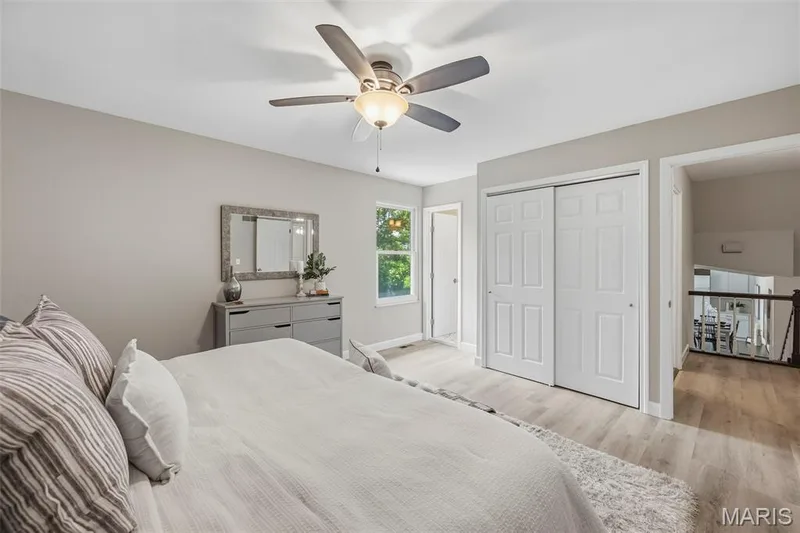 Spacious upper level primary suite offers LVP flooring, ceiling fan with light, fresh paint, and a private en suite bath. — 3034 Willow Wood Drive, St Charles, MO 63303