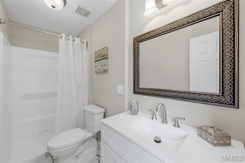 En suite bath features LVT flooring, adult height vanity, and a convenient step in shower. — 3034 Willow Wood Drive, St Charles, MO 63303