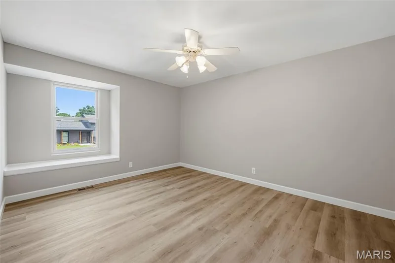 Upper level bedroom 3 features a professionally painted interior, LVP flooring, and ceiling fan with light. — 3034 Willow Wood Drive, St Charles, MO 63303