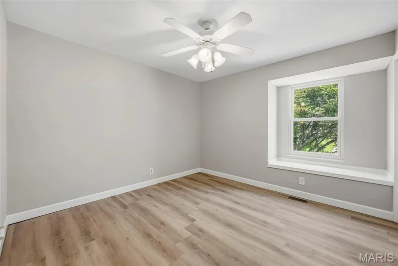 Upper level bedroom 4 features a ceiling fan with light, professionally painted interior, and LVP flooring. — 3034 Willow Wood Drive, St Charles, MO 63303