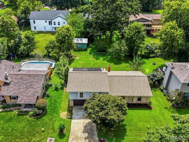 Aerial view showcasing the home’s large, level fenced backyard, offering plenty of space for outdoor enjoyment and entertaining. — 3034 Willow Wood Drive, St Charles, MO 63303